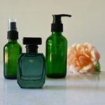 Three signature Fleur Muette green bottles for social media.